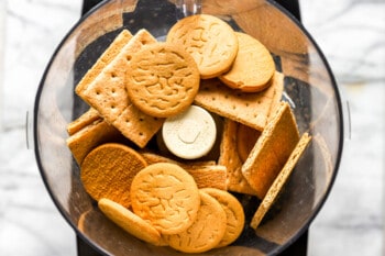 A food processor filled with cookies and crackers.