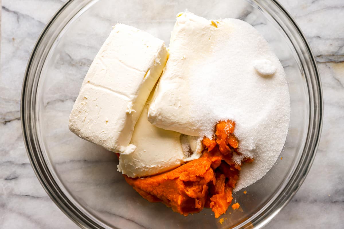 cream cheese, sugar, and sweet potato in a glass bowl.