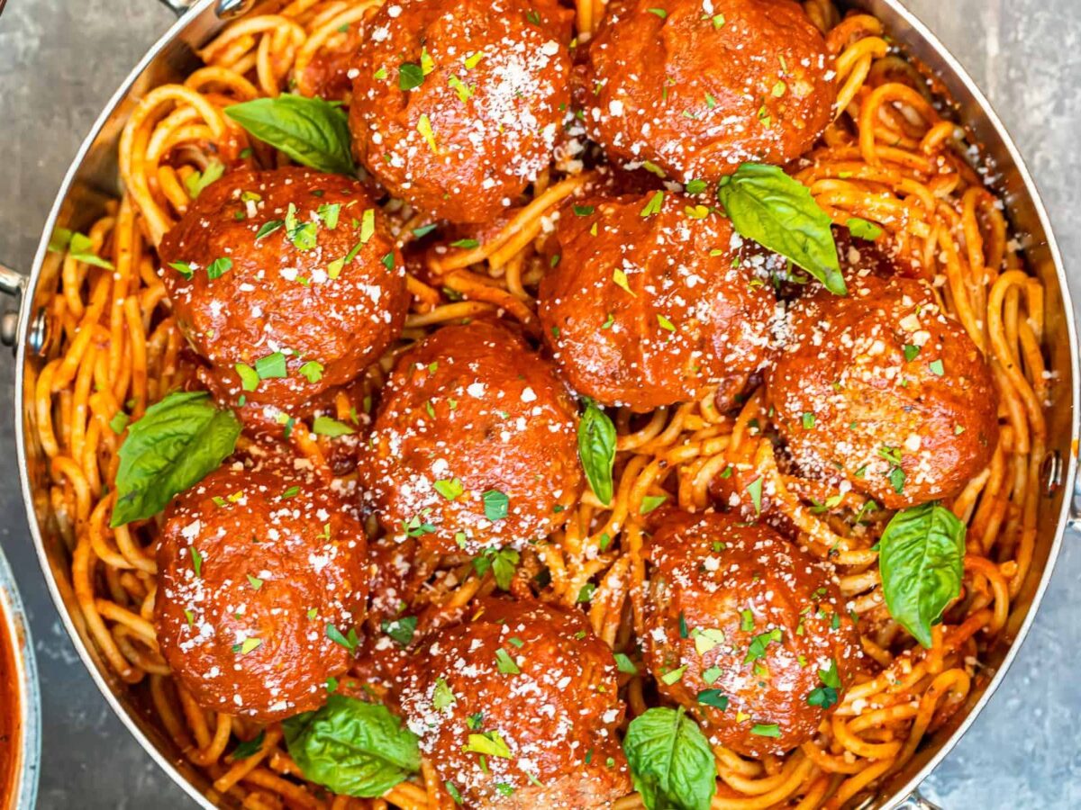 meatballs over pasta in pan