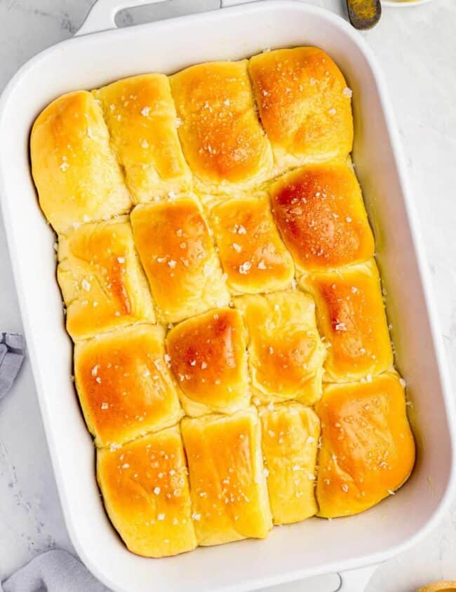 parker house rolls in a white baking pan.