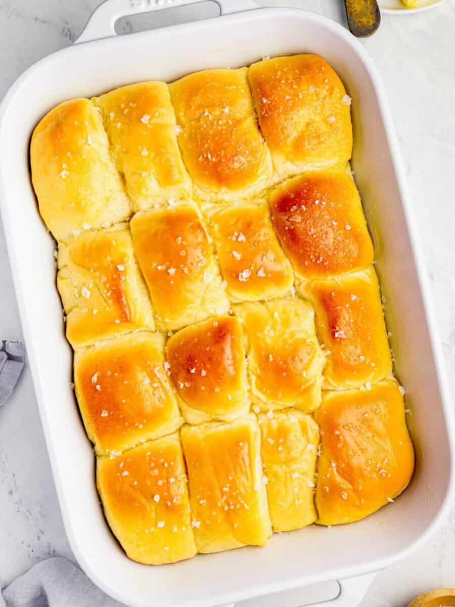 parker house rolls in a white baking pan.