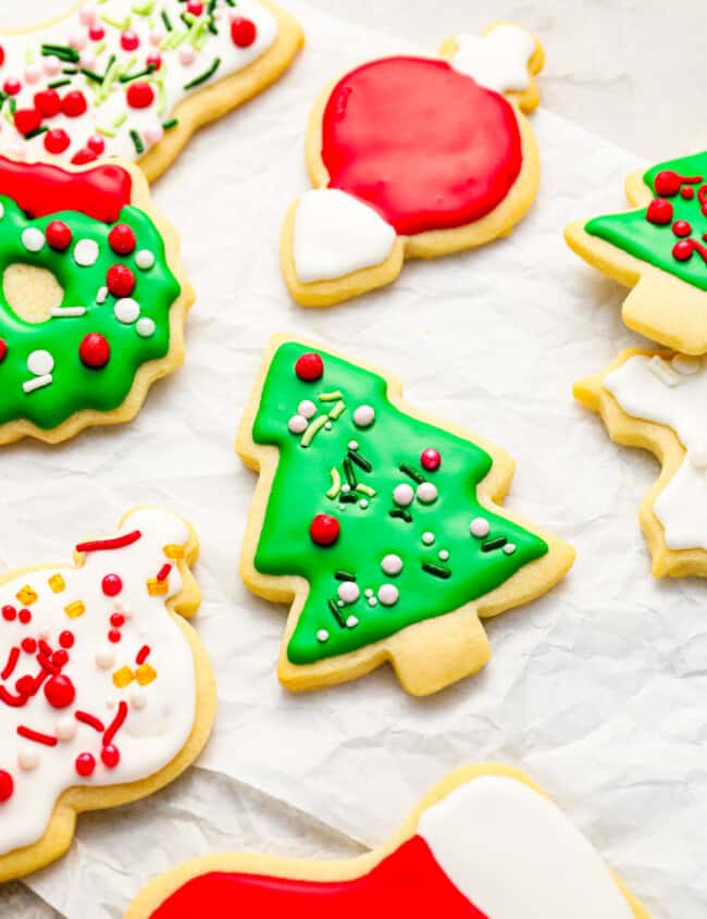 A bunch of decorated christmas cookies on a piece of paper.