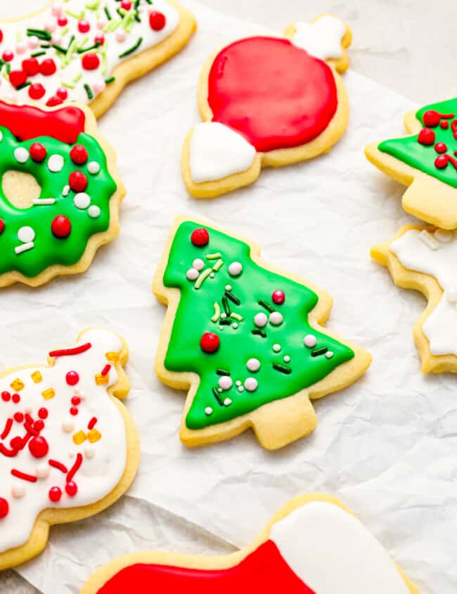 A bunch of decorated christmas cookies on a piece of paper.