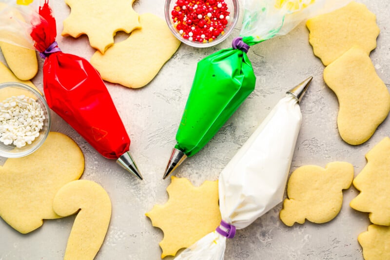 A group of cookies with icing and sprinkles on a table.