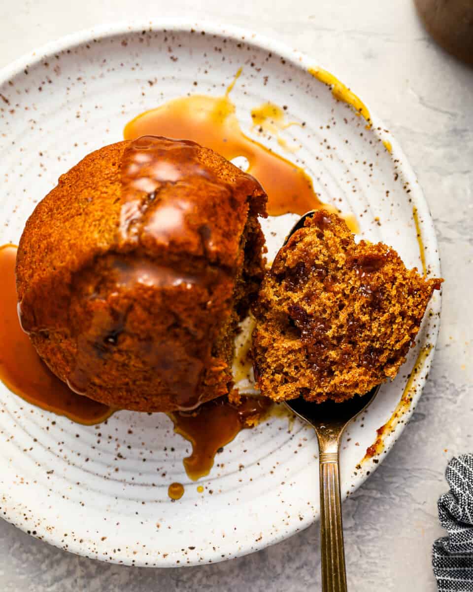 sticky toffee pudding with sauce on top and a fork.