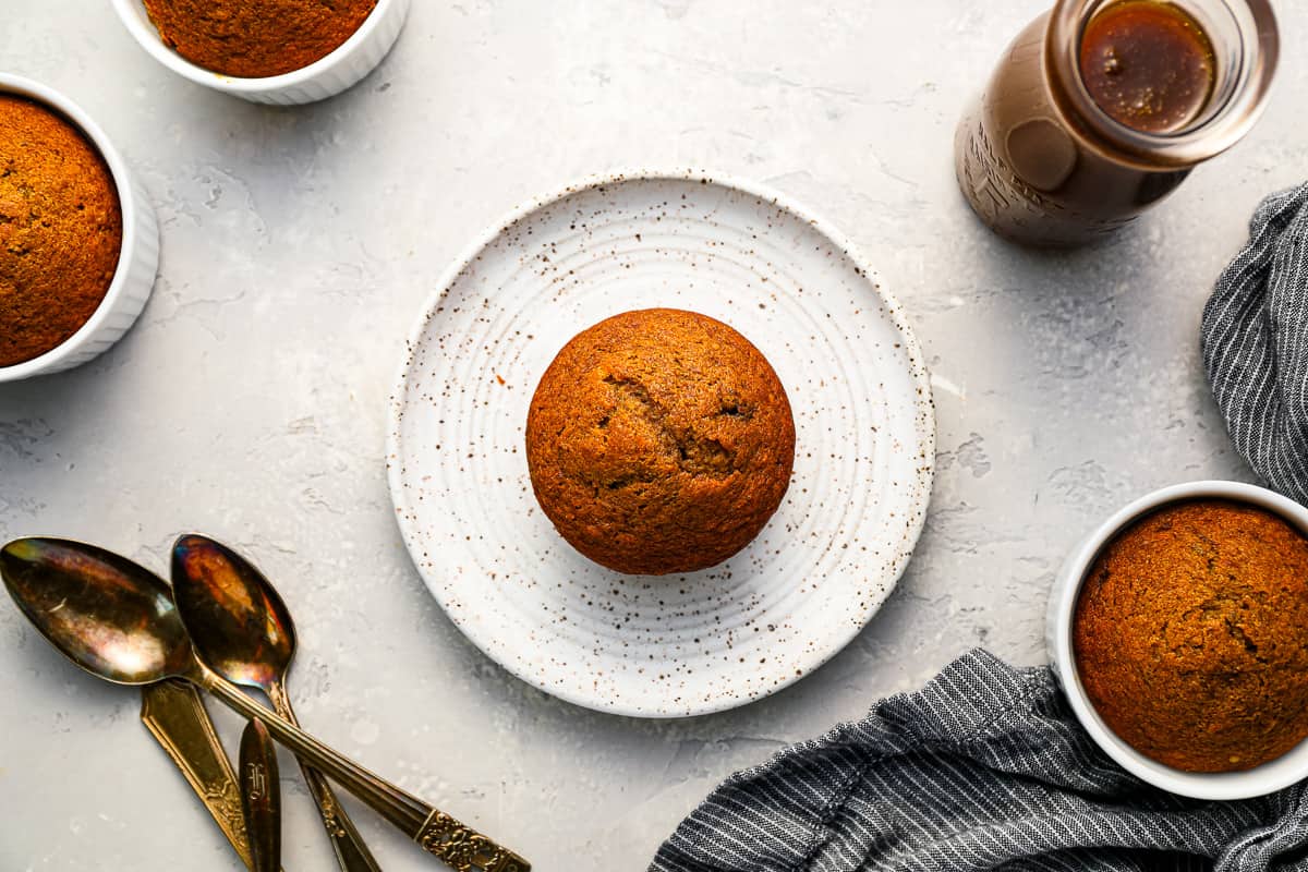 date cakes on a white plate with sticky toffee sauce.