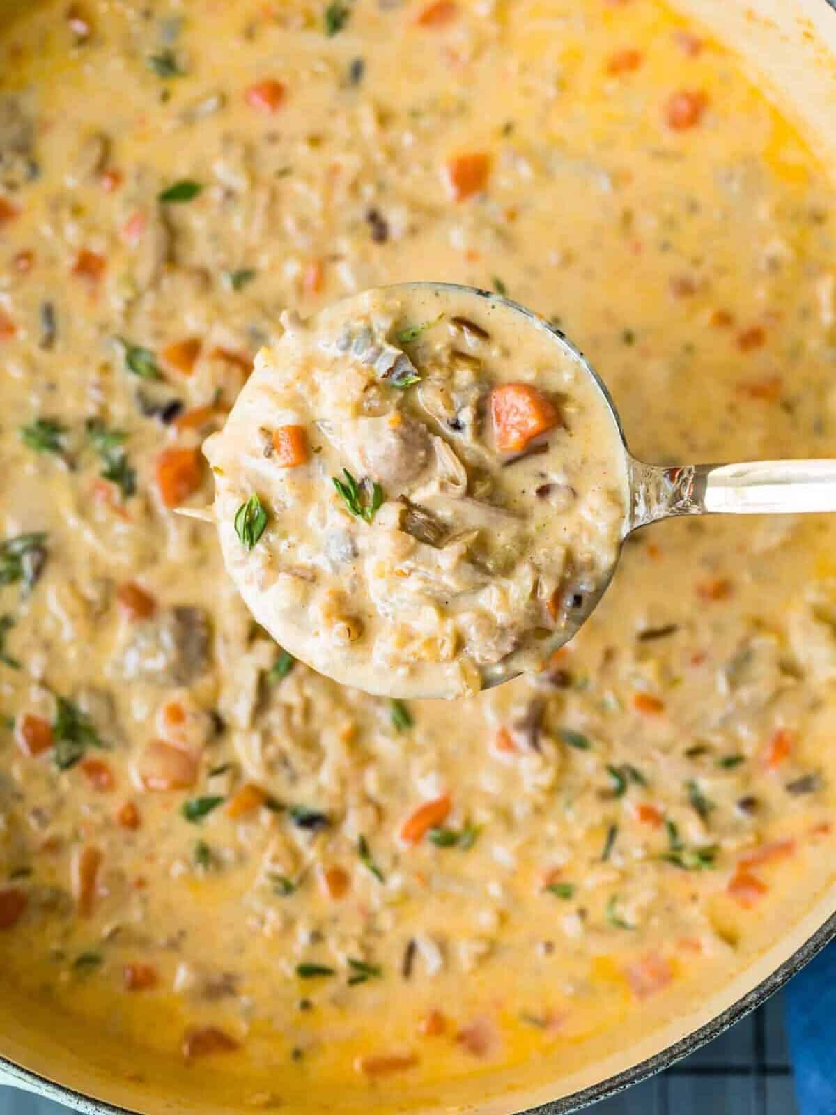 Turkey wild rice soup in a ladle 