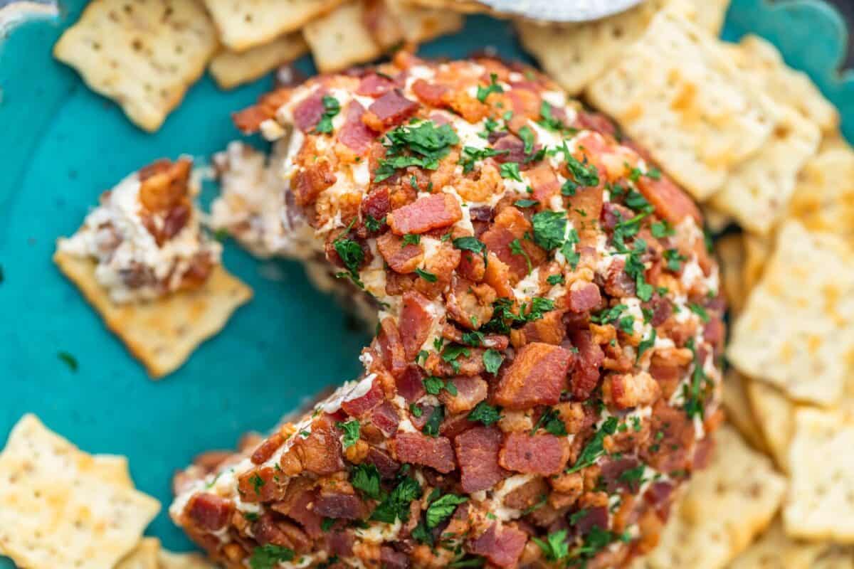 Bacon ranch cheese ball served with crackers on a plate.