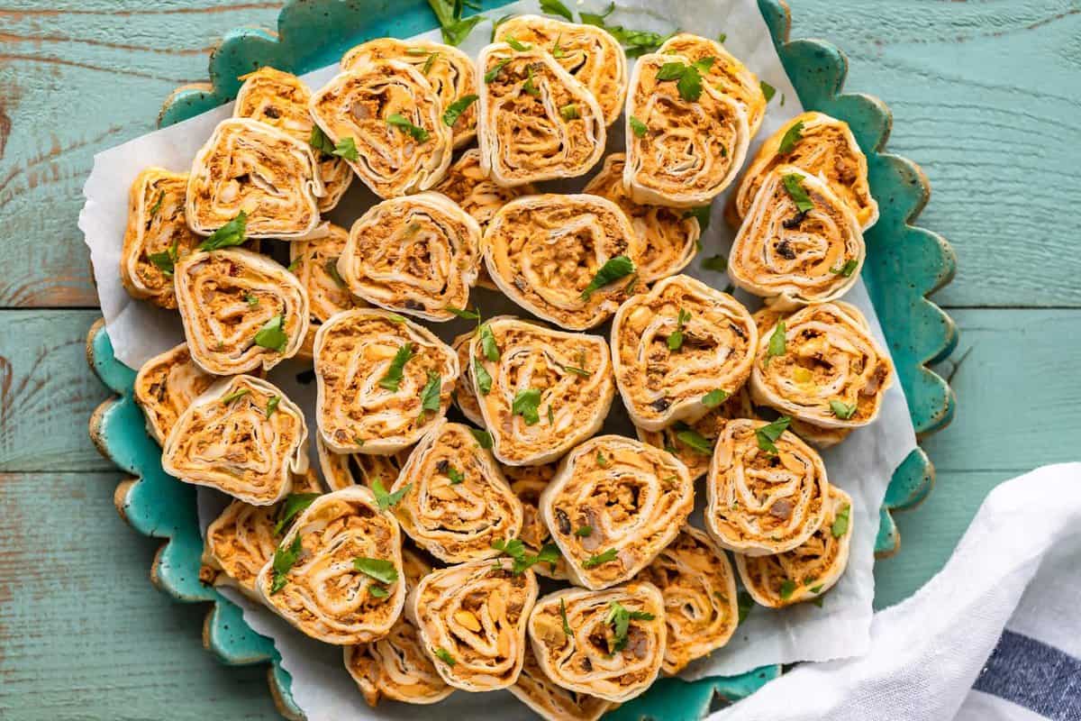 mexican pinwheels on a blue plate.