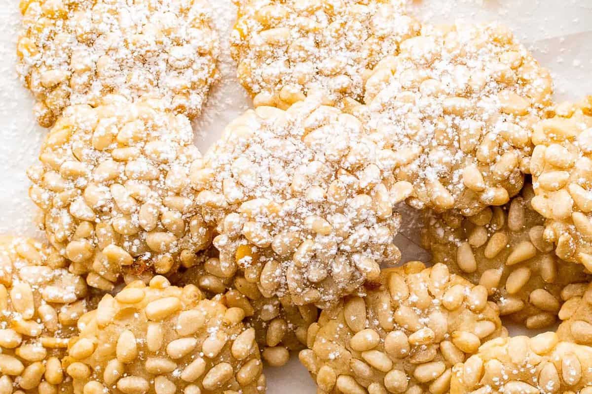 overhead image of pine nut cookies with a dusting of powdered sugar
