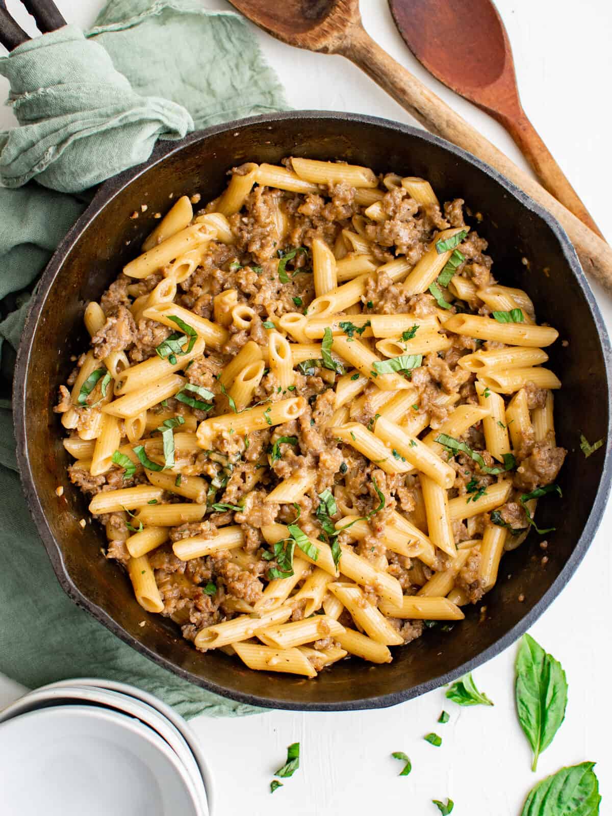 overhead view of Italian sausage pasta in a cast iron pan.