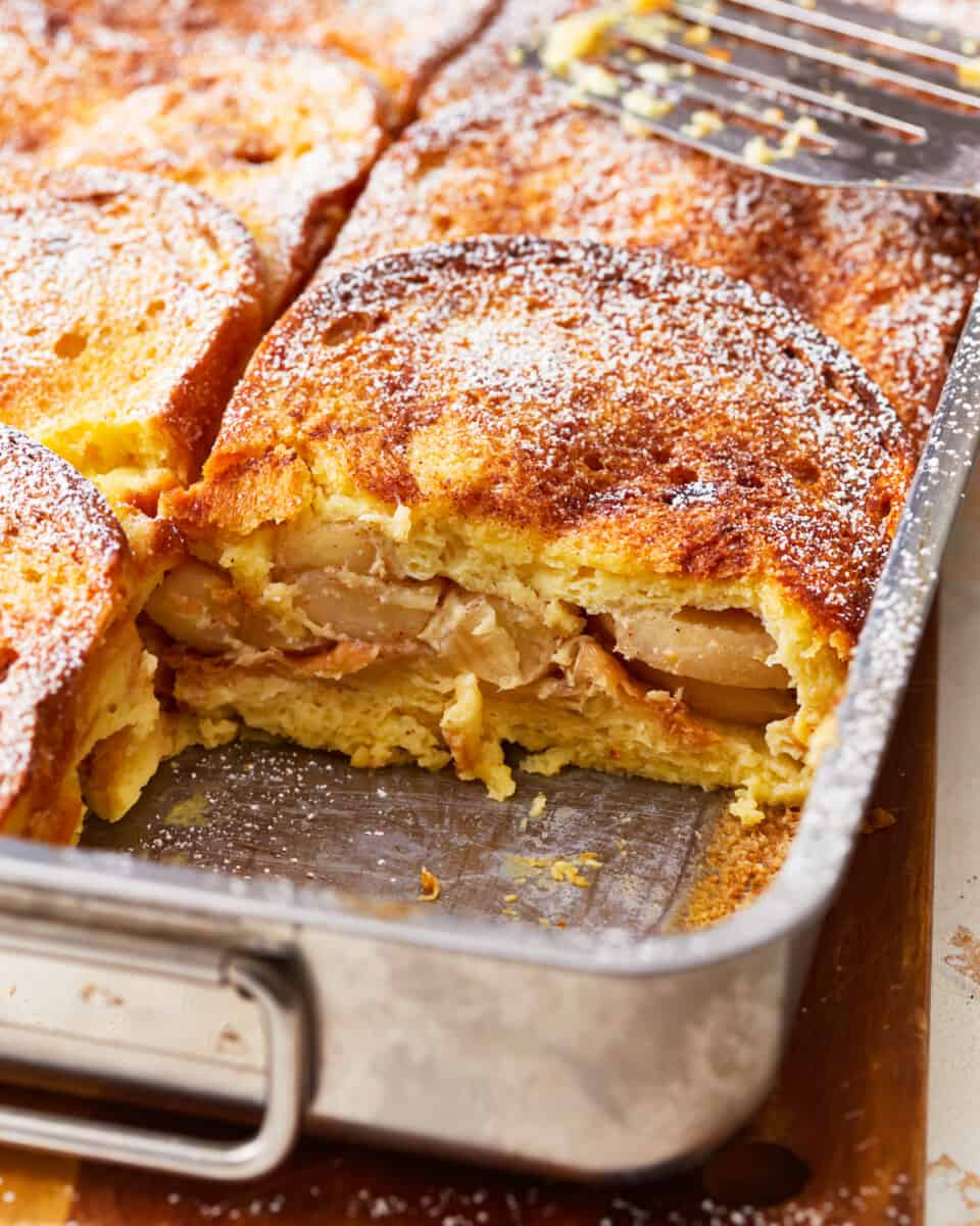 An apple french toast casserole in a pan with a fork.