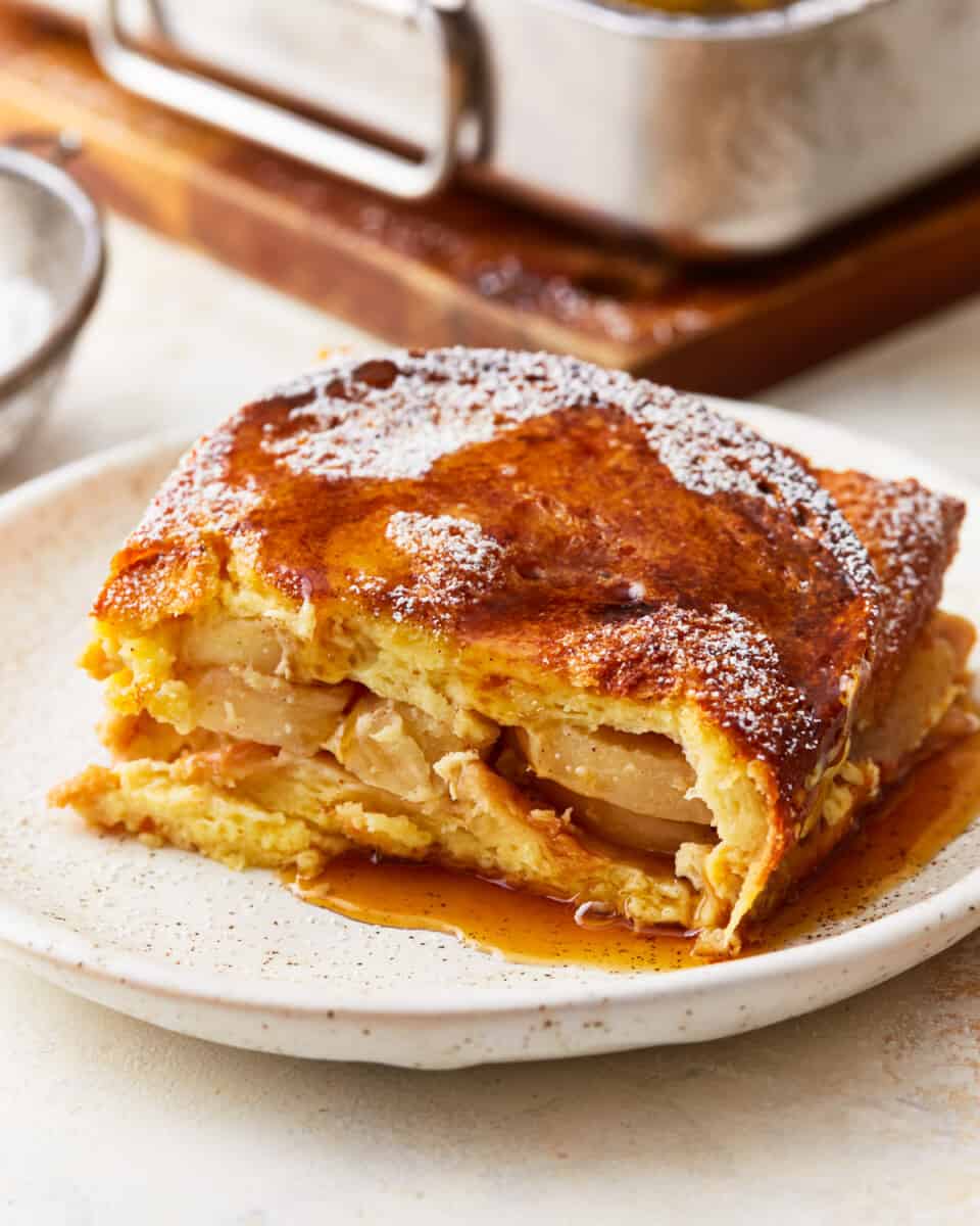 A piece of apple French toast casserole on a plate.