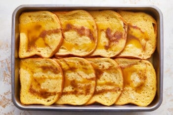 Sliced french toast in a baking pan.