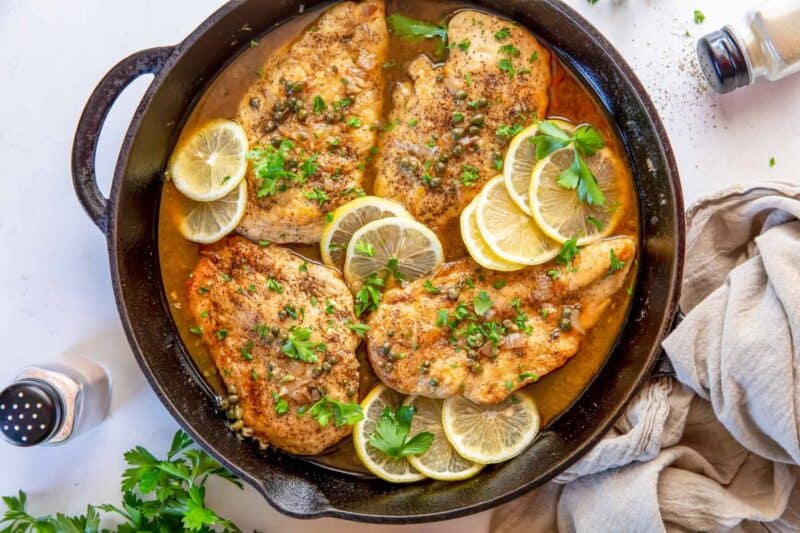 Overhead view of chicken piccata in a skillet.