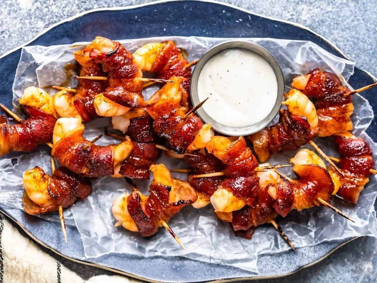overhead view of a serving platter filled with shrimp wrapped in bacon