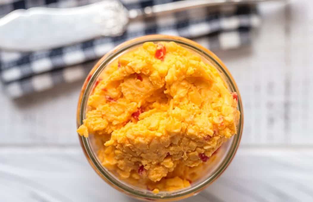 overhead view of pimento cheese in. a glass jar.