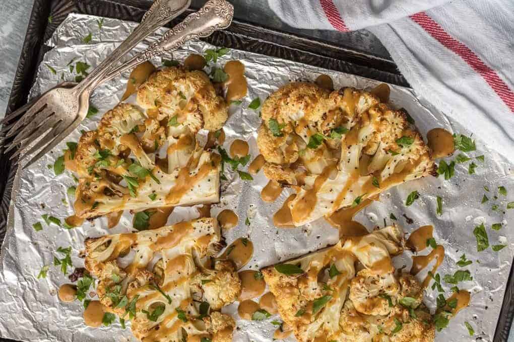 Cauliflower Steaks covered in a Thai Peanut Sauce