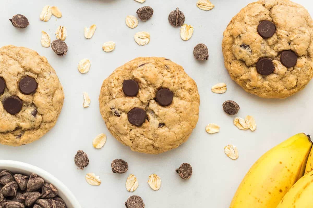 overhead view of banana oatmeal cookies surrounded by oats and chocolate chips.