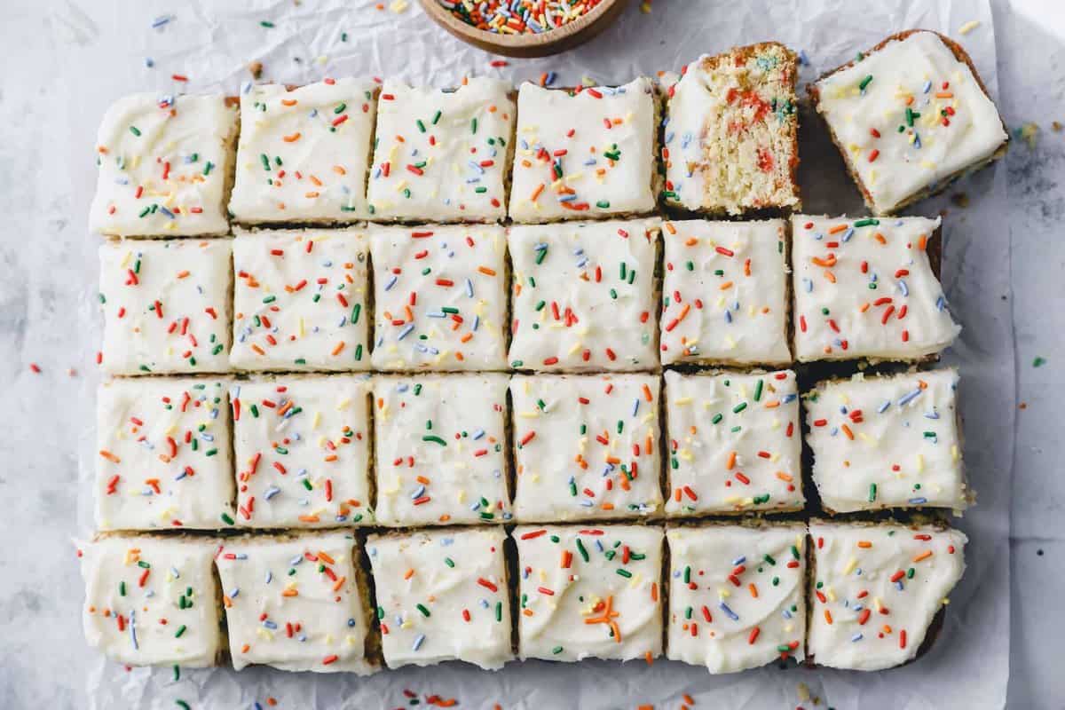 overhead view of a funfetti sheet cake cut into squares