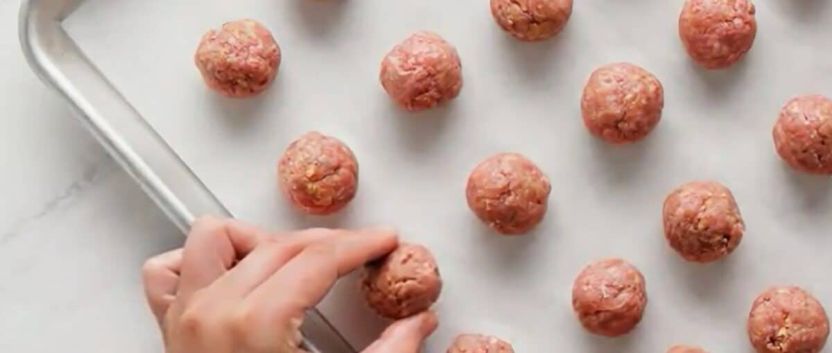 Meatballs on a lined baking sheet. 