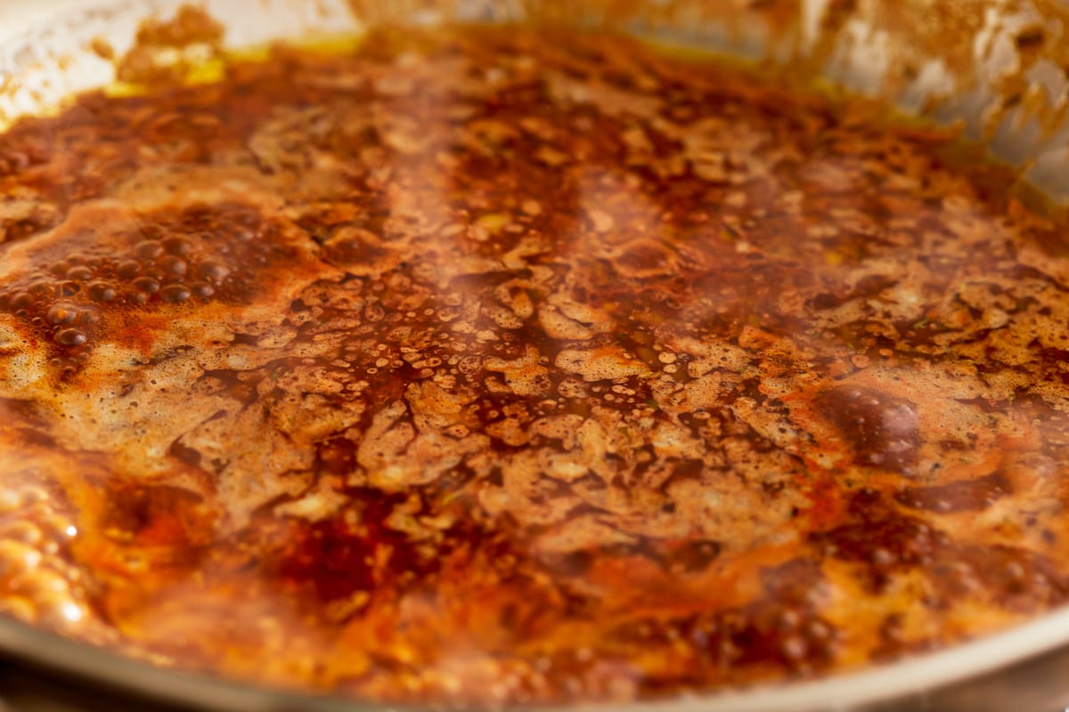 A pot of BBQ sauce is being cooked in a pan.