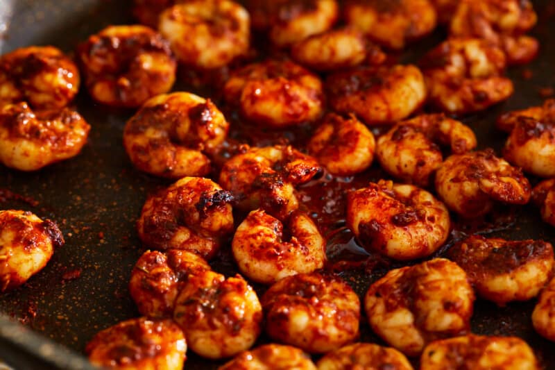 Blackened shrimp in a frying pan.