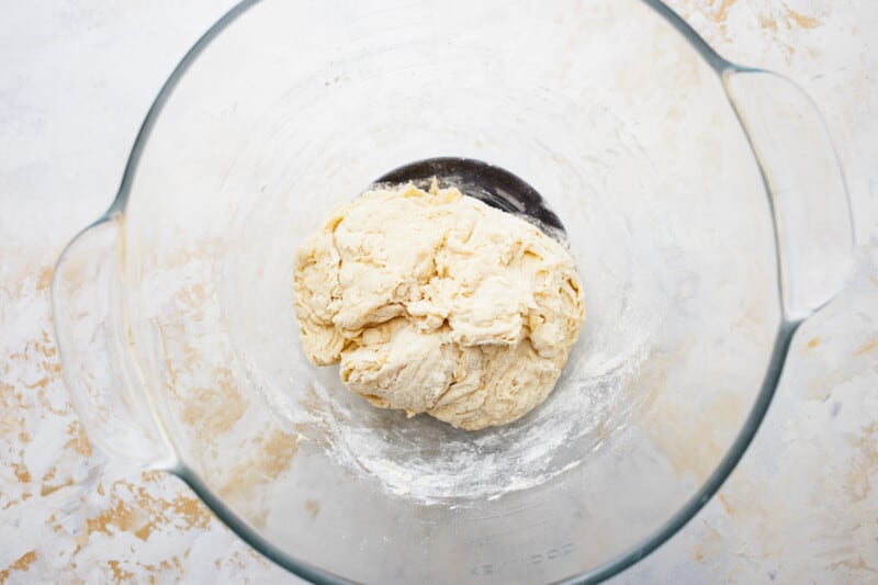 French baguette dough in a glass bowl.