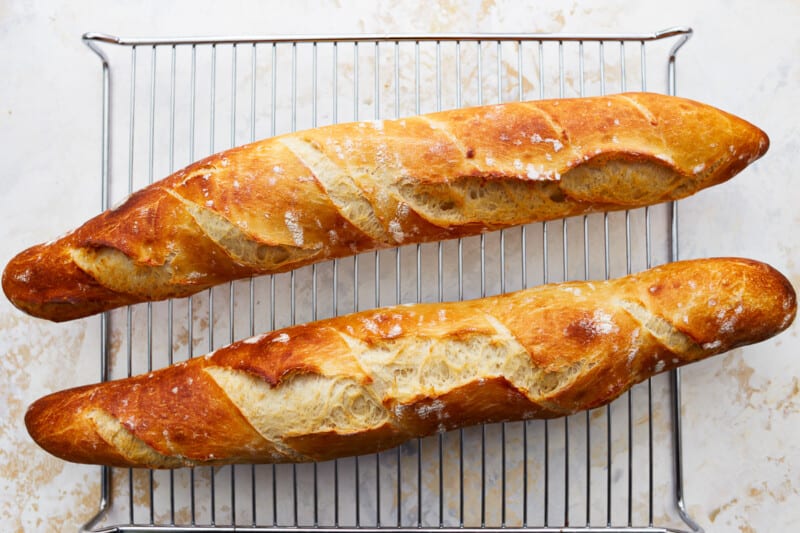 Two slices of French baguette on a cooling rack.