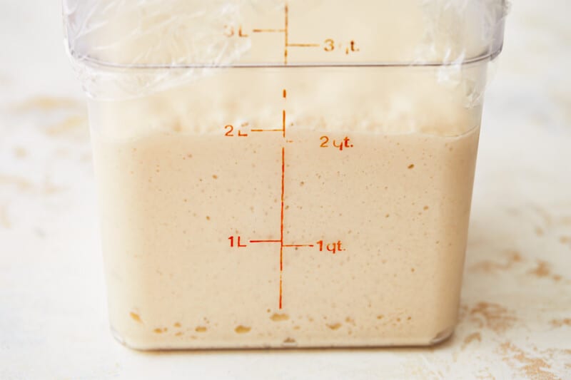 A plastic container shaped like a French baguette with a measuring tape on it.