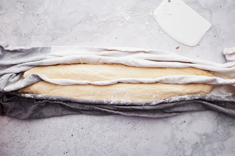 A French baguette on a marble countertop.