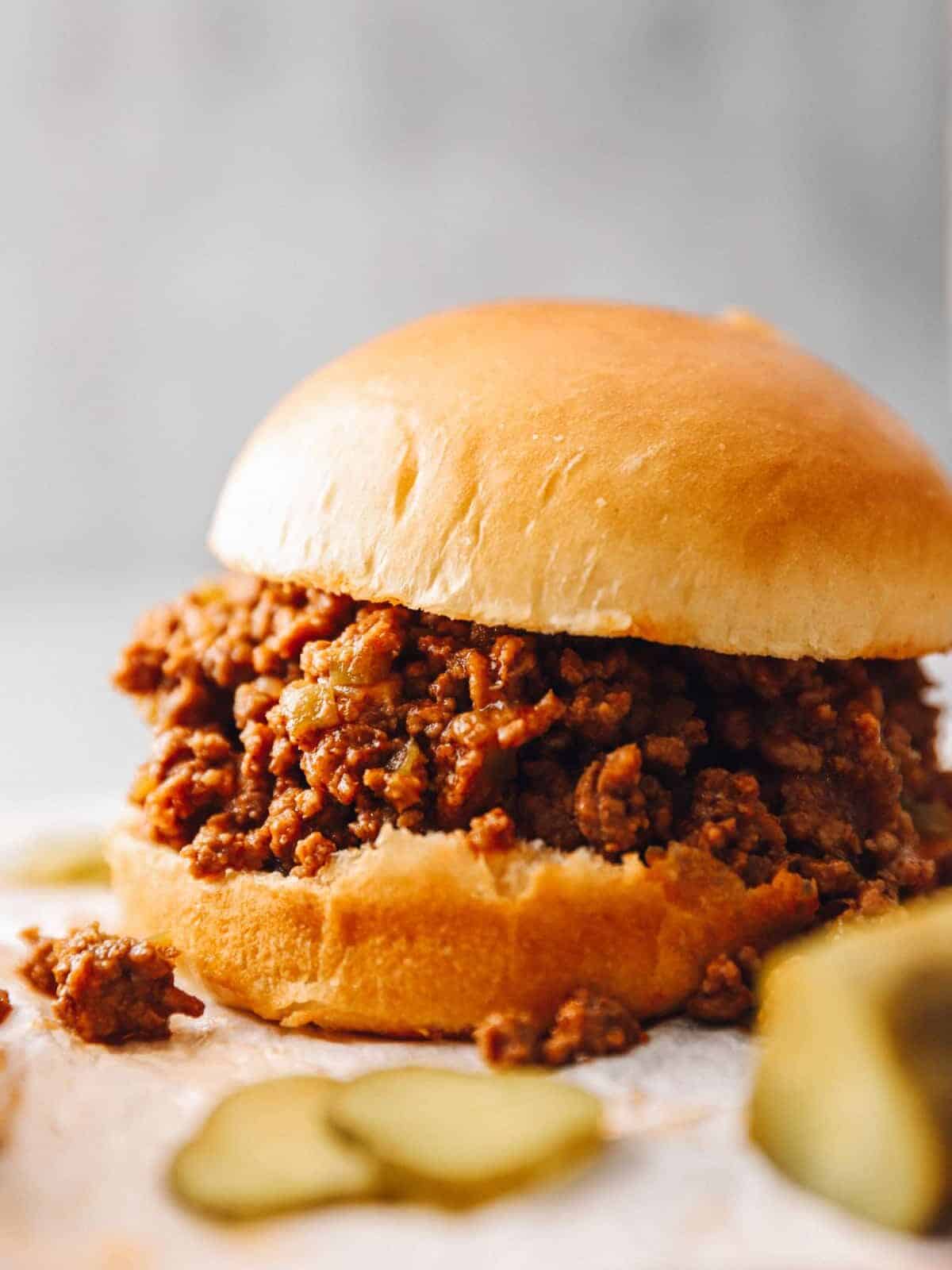 an instant pot sloppy joe sandwich with pickles.