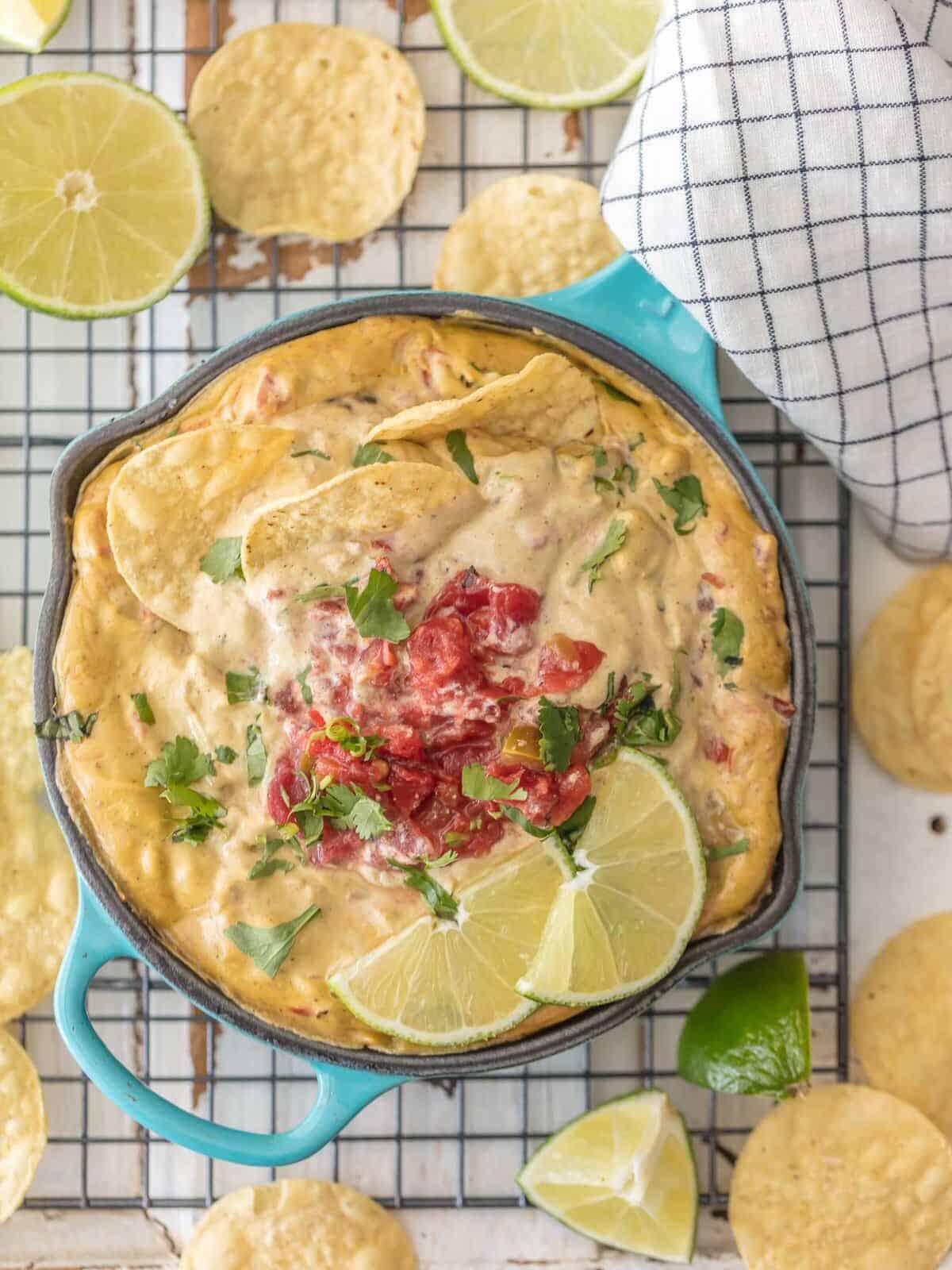 Vegan Queso topped with rotel, lime wedges, and tortilla chips