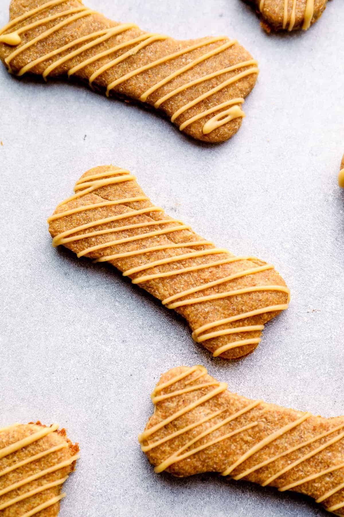 peanut butter dog treats drizzled with dog friendly icing