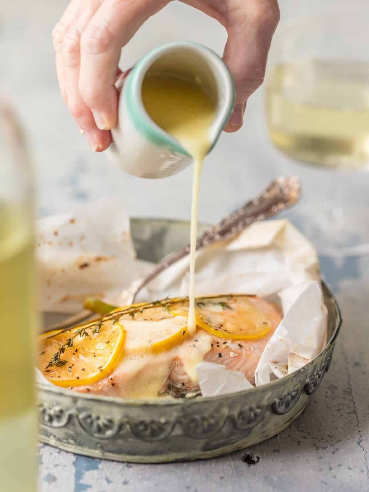 close up view of lemon butter being poured onto salmon