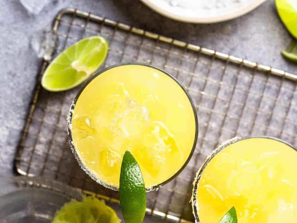 overhead view of a margarita in a rocks glass with a lime wedge.