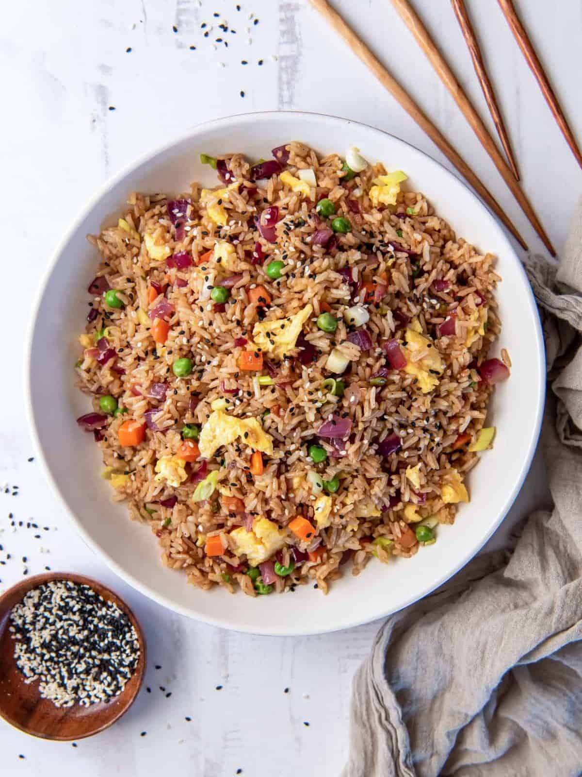 overhead view of vegetable fried rice in a white bowl.