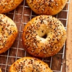 everything bagel seasoned bagels on a wire rack.