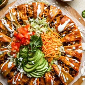 overhead view of a taco ring drizzled with sour cream.