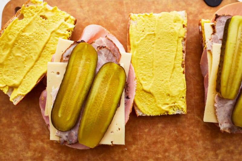 open-faced cuban sandwich on a cutting board.