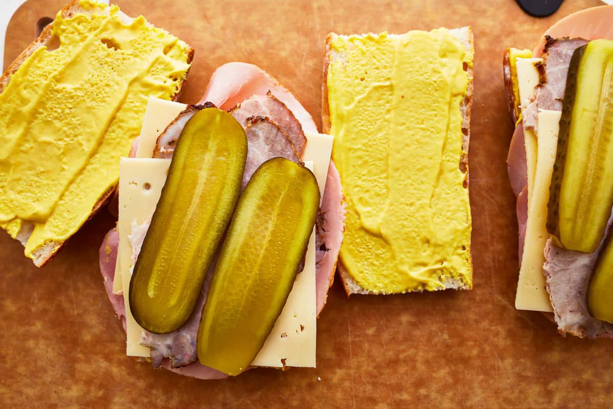 open-faced cuban sandwich on a cutting board.