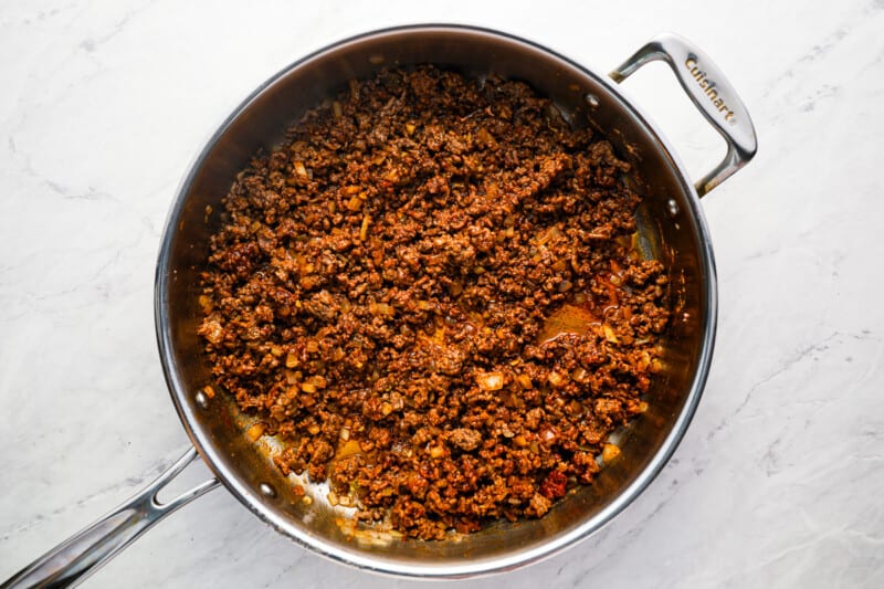seasoned ground beef in a stainless pan.