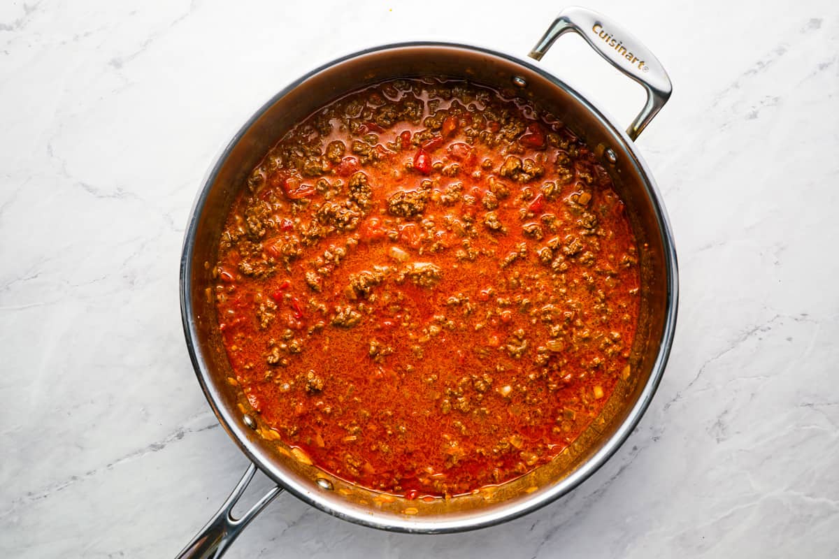 saucy ground beef in a stainless pan.