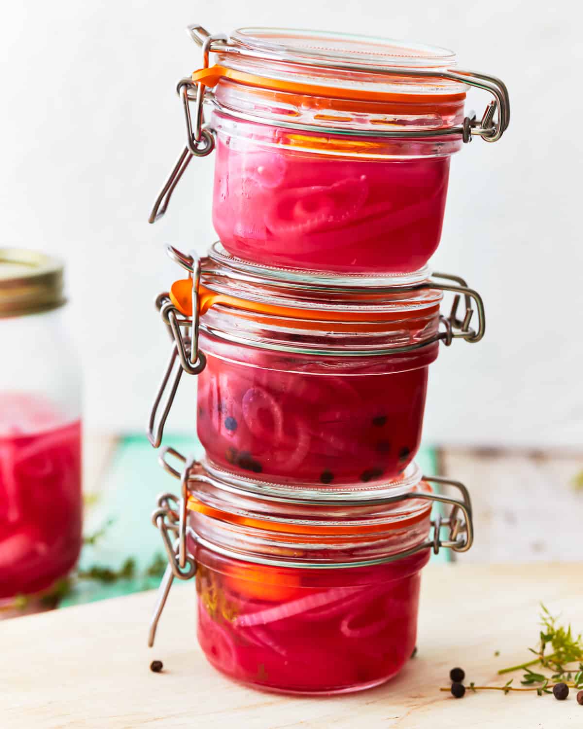 3 stacked jars of pickled red onions.