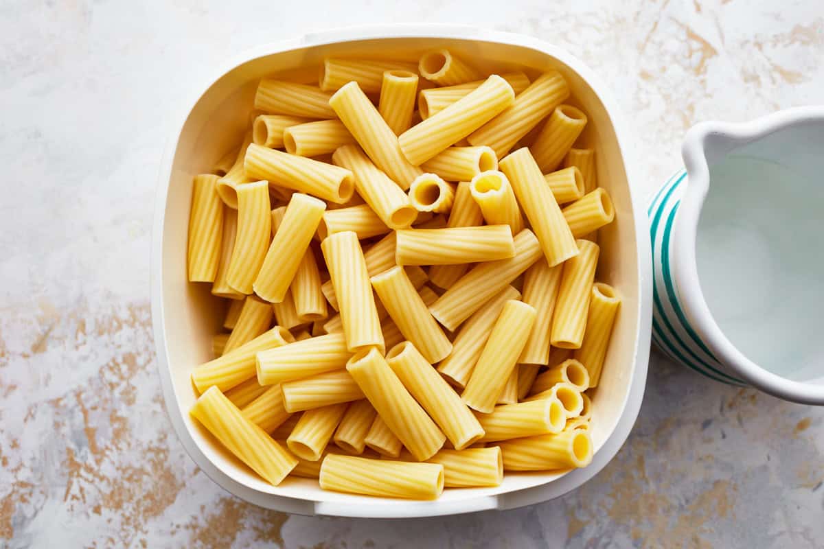 cooked rigatoni in a white bowl.