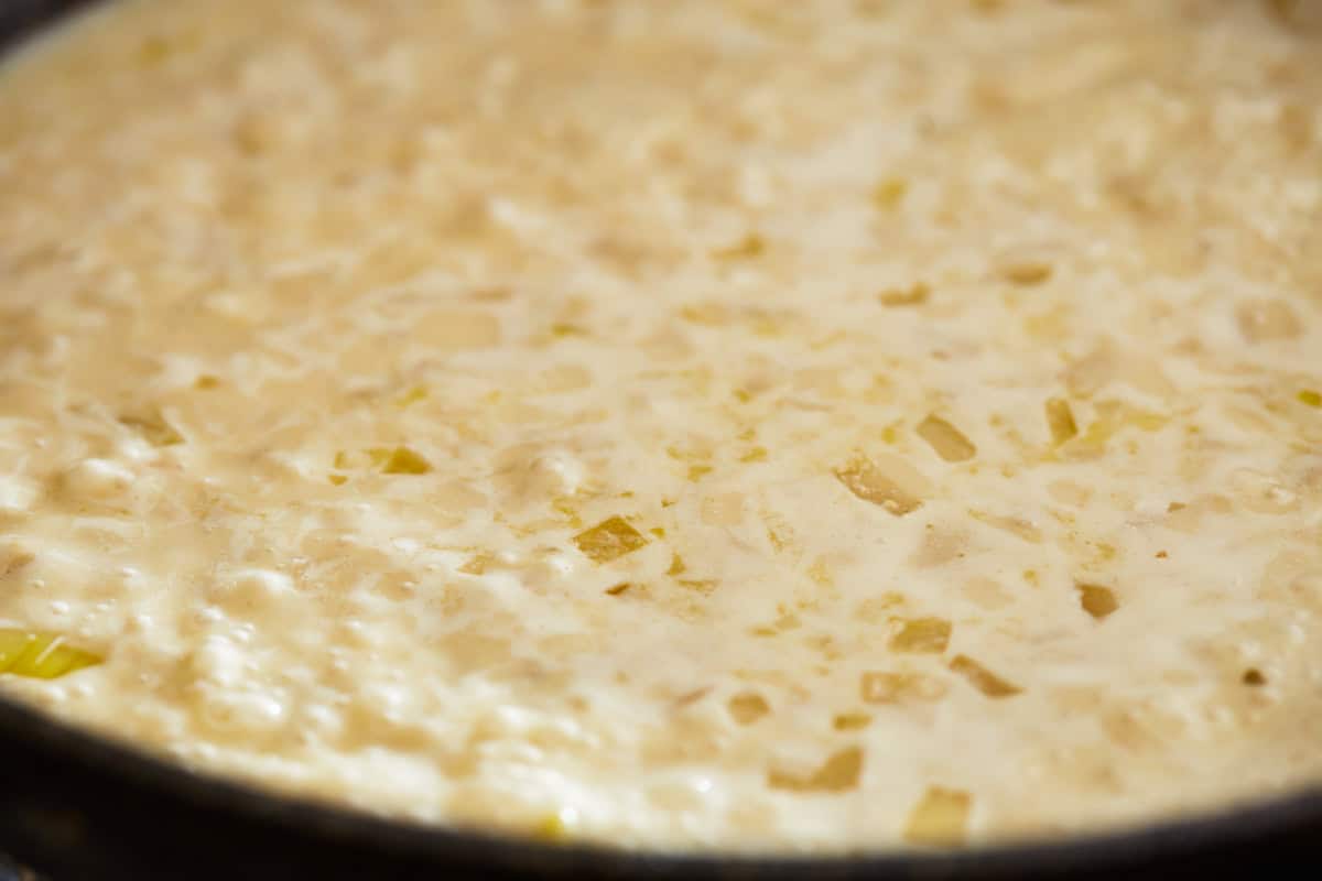 creamy sauce simmering in a pan.