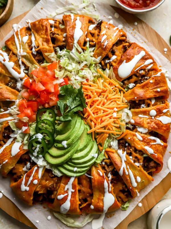 overhead view of a taco ring drizzled with sour cream.