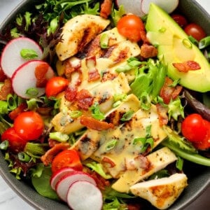 close up view of honey mustard chicken salad in a bowl.