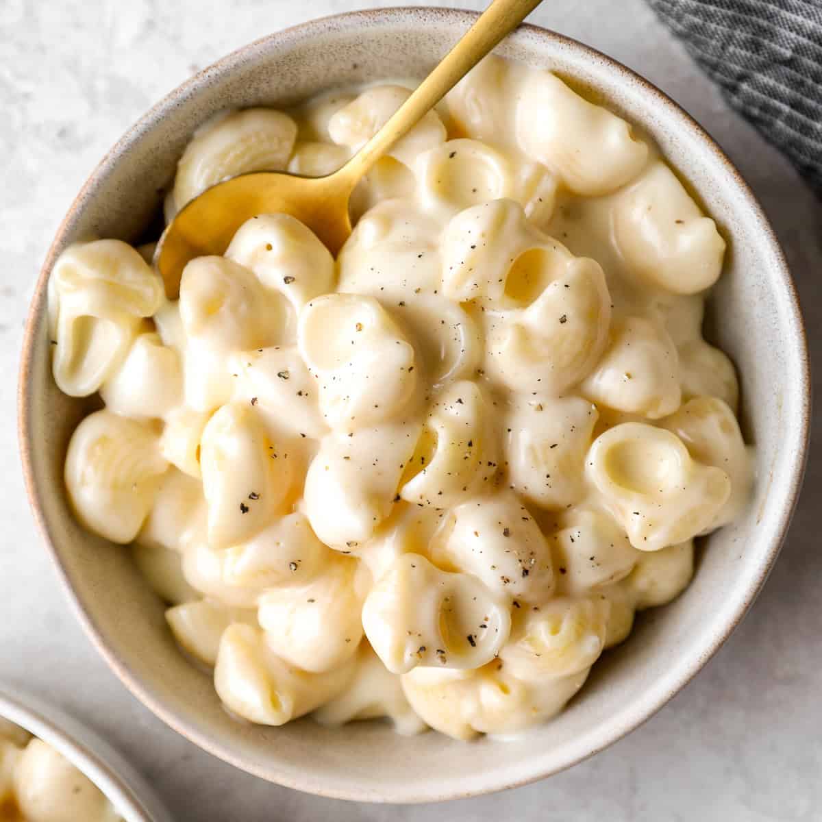 Overhead view of a bowl of Panera mac and cheese with a spoon.