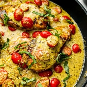 pesto chicken in a skillet.